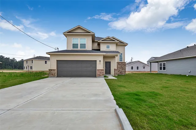 a front view of house with yard and green space