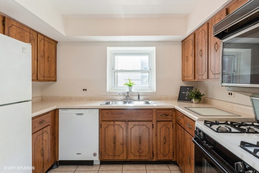 644 Raupp Boulevard Buffalo Grove, IL 60089 - Photo 6 of 23 a kitchen with a sink stove and cabinets
