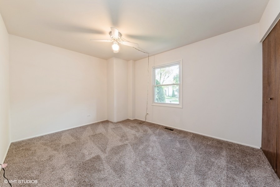 644 Raupp Boulevard Buffalo Grove, IL 60089 - Photo 9 of 23 an empty room with windows and fan