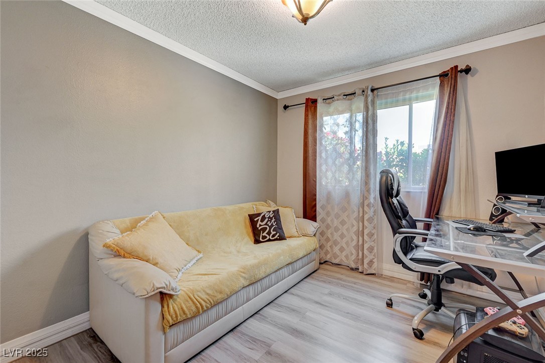 3266 Mountain Spring Road Las Vegas, NV 89146 - Photo 22 of 49 Office area with baseboards, wood finished floors, a textured ceiling, and ornamental molding