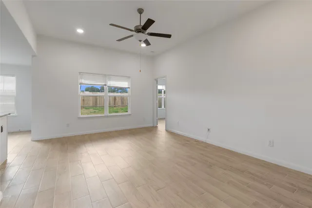 a view of a kitchen with a sink and a refrigerator