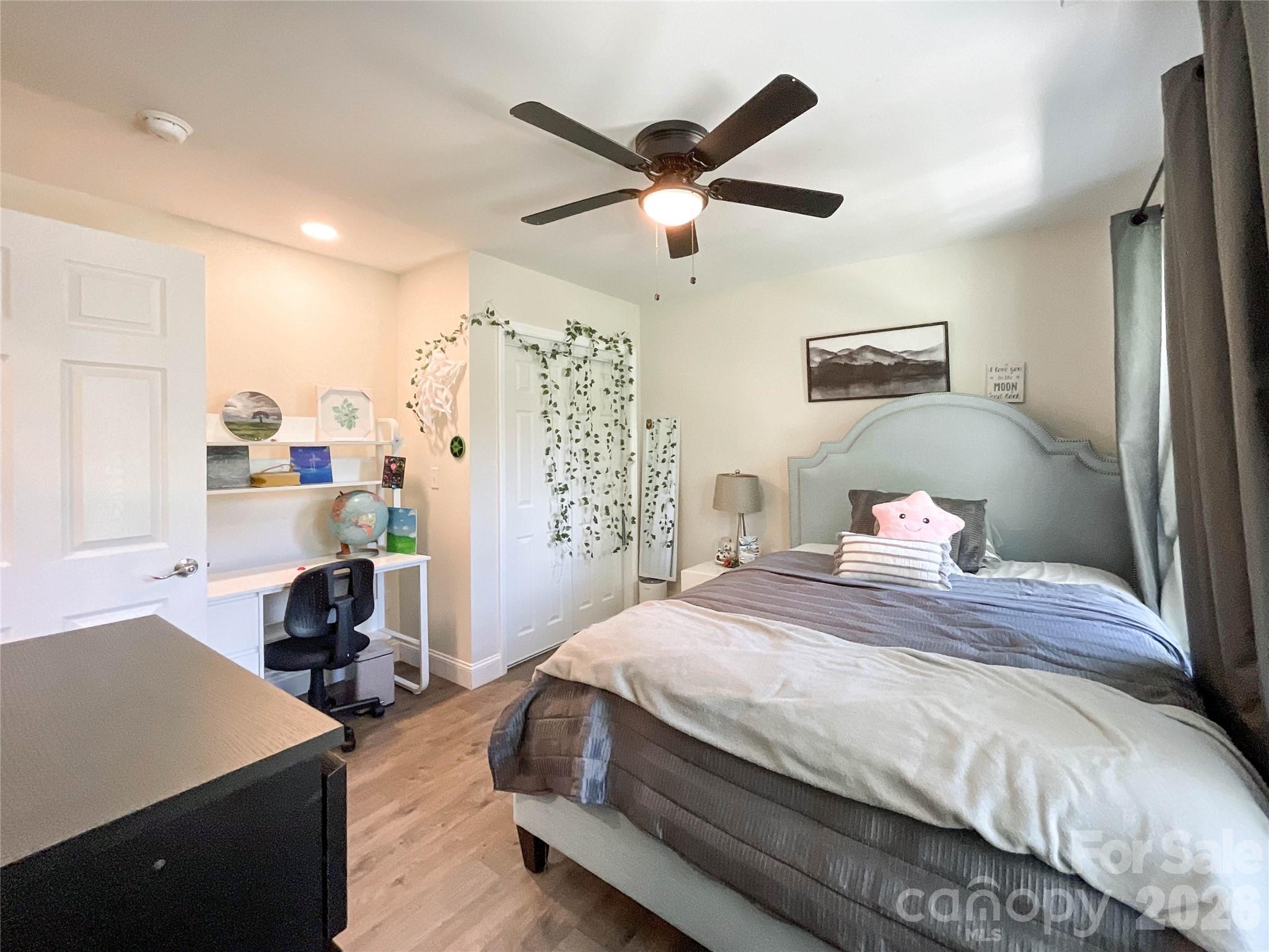 404 White Store Road Wadesboro, NC 28170 - Photo 5 of 38 a bedroom with a bed and a chandelier