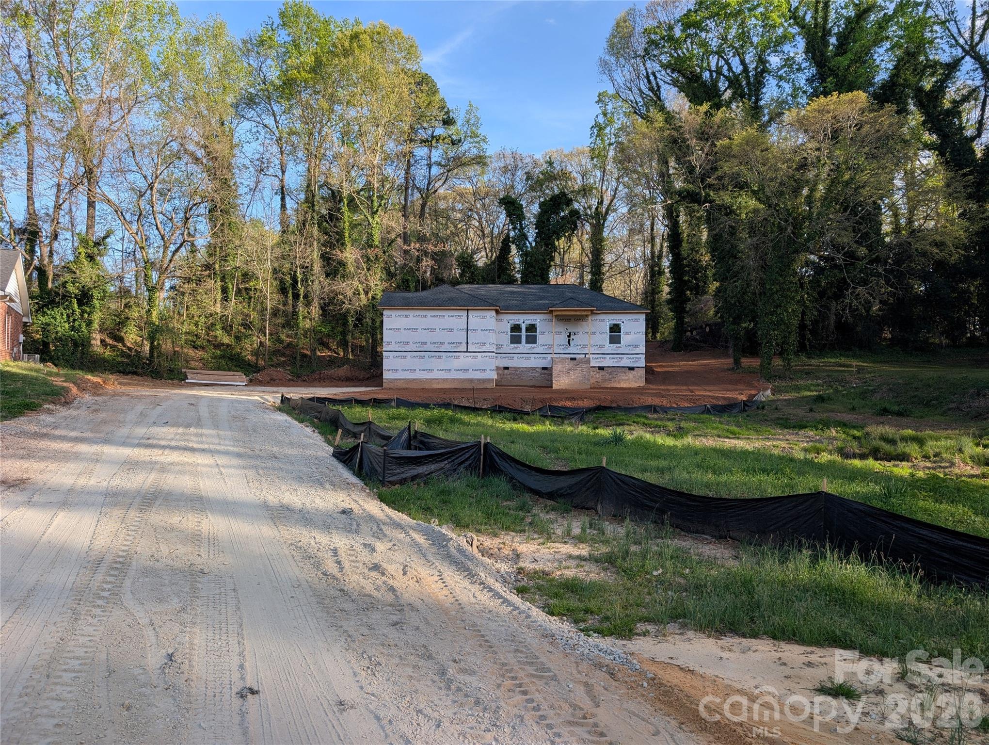 323 Oak Street York, SC 29745 - Photo 3 of 5 a front view of a house with a garden and lake view