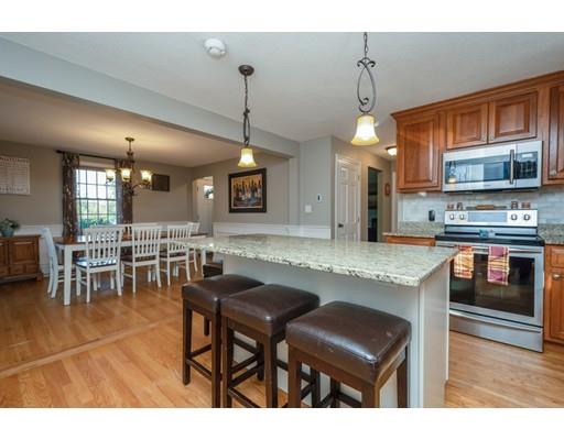 20 Launching Road Andover, MA 01810 - Photo 11 of 33 a kitchen with stainless steel appliances granite countertop table chairs and a refrigerator