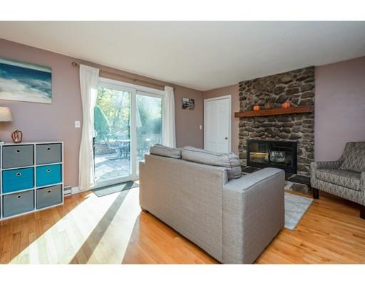 20 Launching Road Andover, MA 01810 - Photo 12 of 33 a living room with furniture a large window and a fireplace