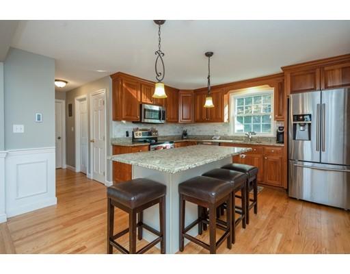 20 Launching Road Andover, MA 01810 - Photo 4 of 33 a kitchen with stainless steel appliances granite countertop a refrigerator a oven a sink with a dining table and chairs