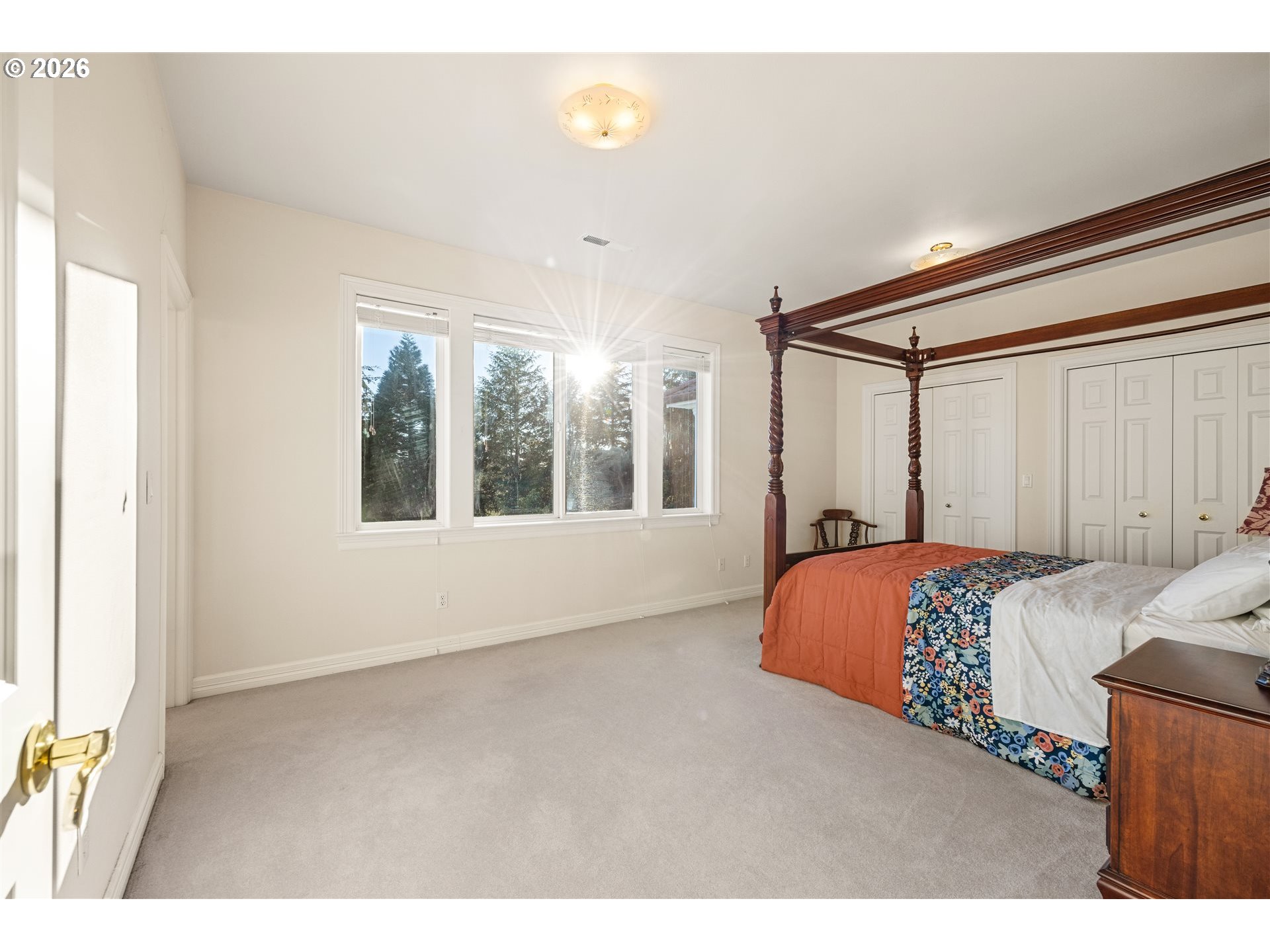 28306 Northeast 24th Avenue Ridgefield, WA 98642 - Photo 36 of 48 a bedroom with a large bed and a large window