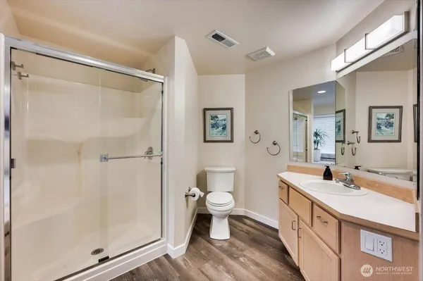 a bathroom with a double vanity sink mirror and toilet