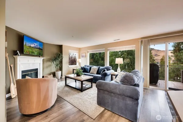 a living room with furniture a fireplace and a flat screen tv