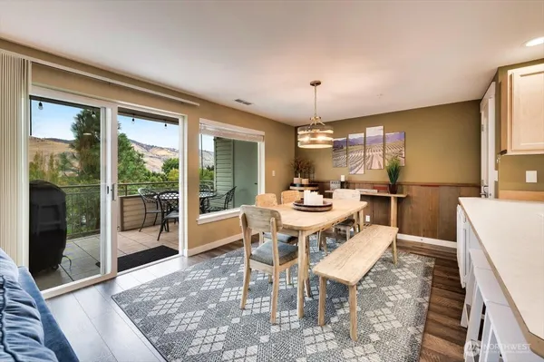 a view of a dining room with furniture wooden floor and chandelier