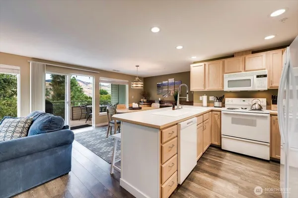 a view of kitchen with windows and ceiling fan