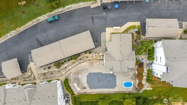an aerial view of residential houses with outdoor space and swimming pool