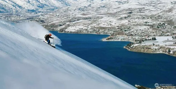 a room with lots of residential buildings and car parked