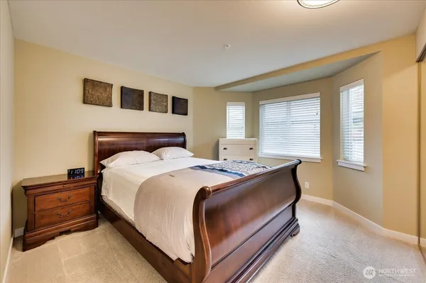 a bed sitting in a bedroom next to a window