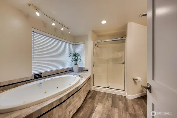 a bathroom with a tub and a shower