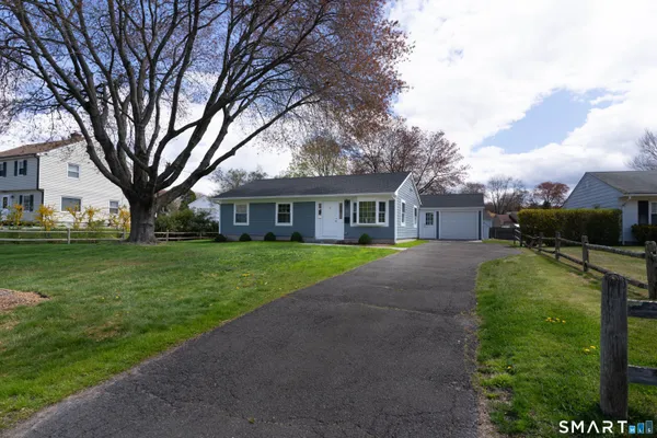 a front view of house with yard and green space