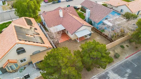 an aerial view of a house with a yard