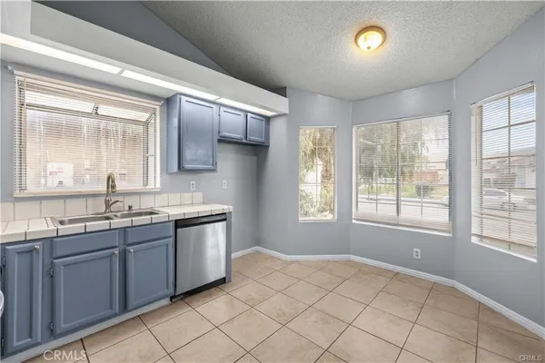a spacious bathroom with a granite countertop sink mirror and window