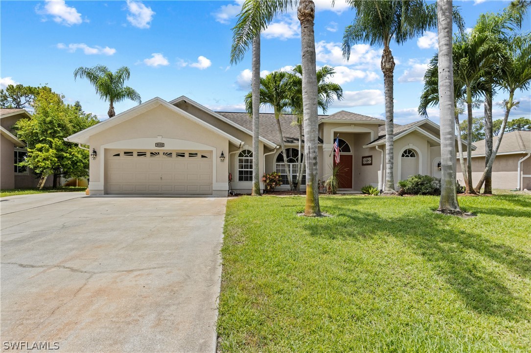 9132 Bryant Road Fort Myers, FL 33967 - Photo 1 of 23 a front view of a house with garden