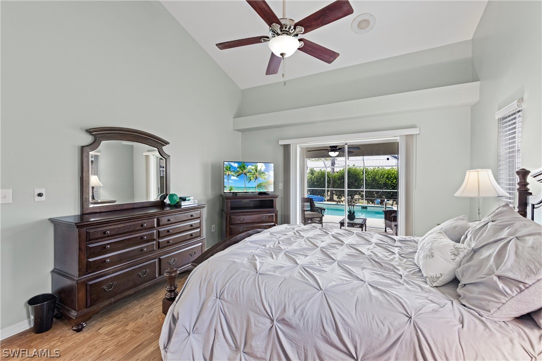 9132 Bryant Road Fort Myers, FL 33967 - Photo 14 of 23 a bedroom with a bed and a large window with wooden floor