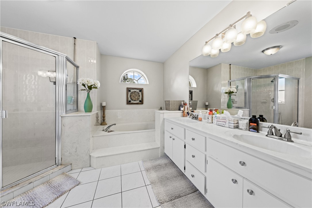 9132 Bryant Road Fort Myers, FL 33967 - Photo 15 of 23 a bathroom with a double vanity sink mirror bathtub and shower
