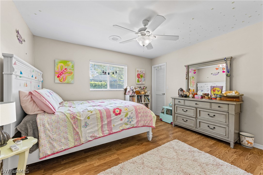9132 Bryant Road Fort Myers, FL 33967 - Photo 16 of 23 a bedroom with a bed and a chandelier