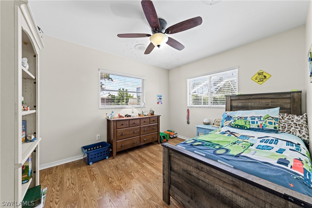 9132 Bryant Road Fort Myers, FL 33967 - Photo 17 of 23 a bedroom with a bed and windows