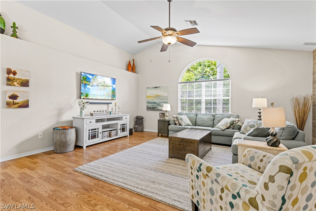 9132 Bryant Road Fort Myers, FL 33967 - Photo 3 of 23 a living room with furniture a fireplace and a flat screen tv