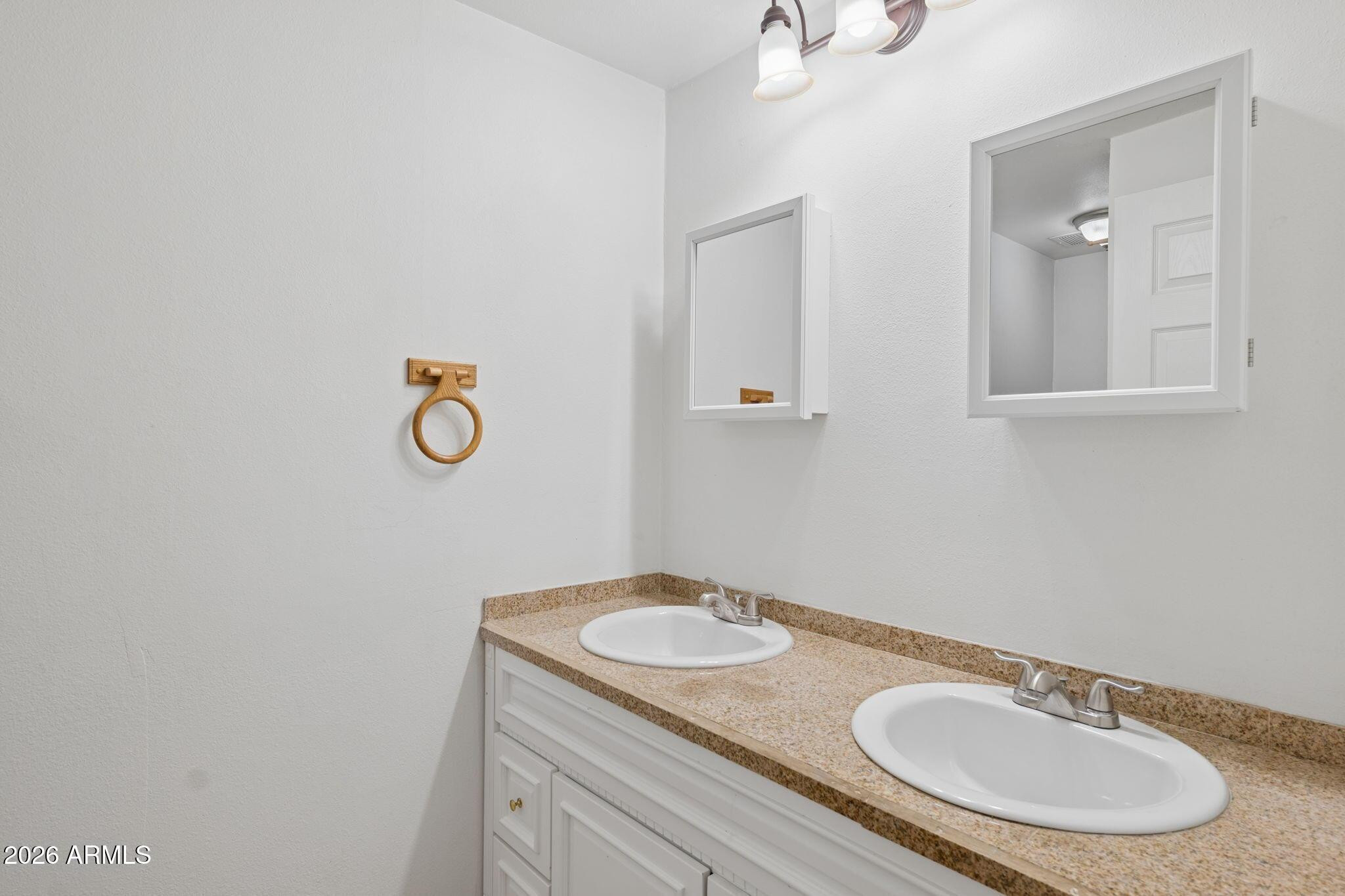 7 South Catalina Street Gilbert, AZ 85233 - Photo 23 of 34 a bathroom with a granite countertop sink and a mirror