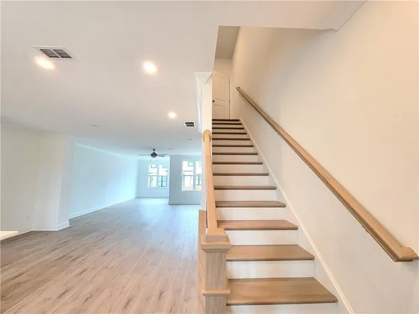 a view of entryway and hall with wooden floor