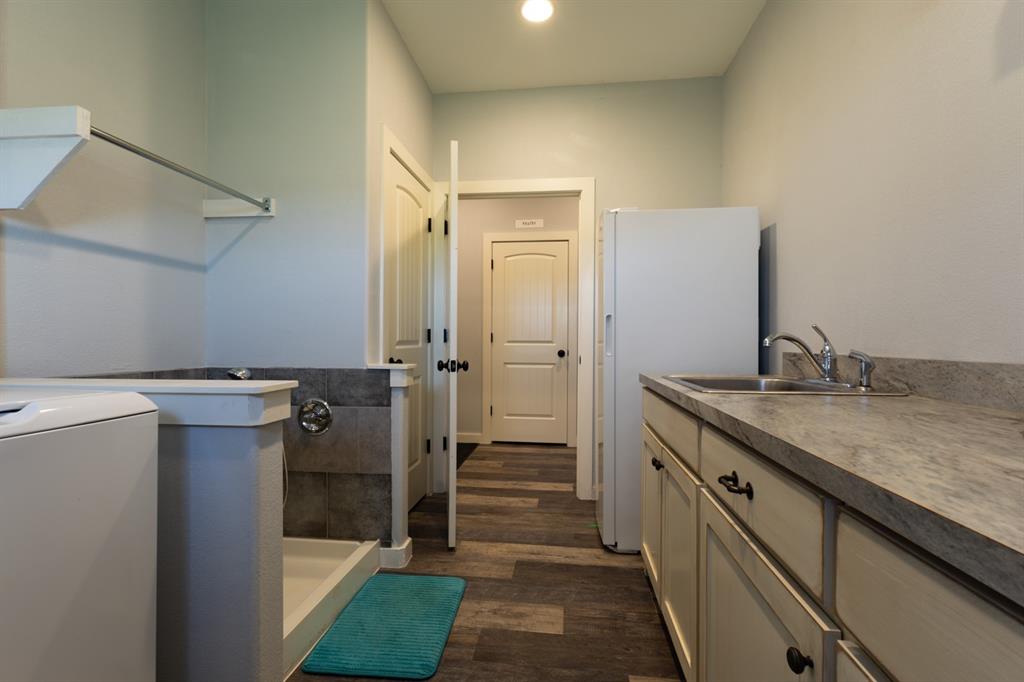 14910 Old Stoney Road Ponder, TX 76259 - Photo 31 of 36 a bathroom with a granite countertop sink mirror and shower