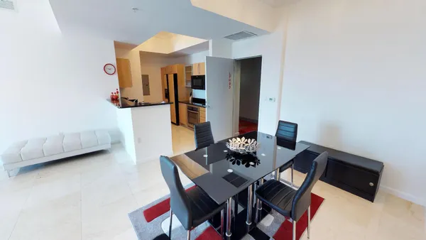 a view of a dining room with furniture and a chandelier