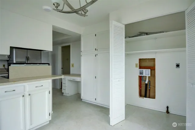 a view of a hallway to closet and utility room