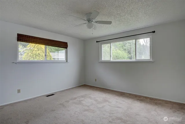 an empty room with windows and closet