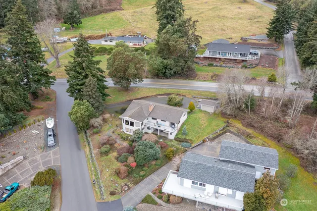 an aerial view of a house with a yard basket ball court and outdoor seating