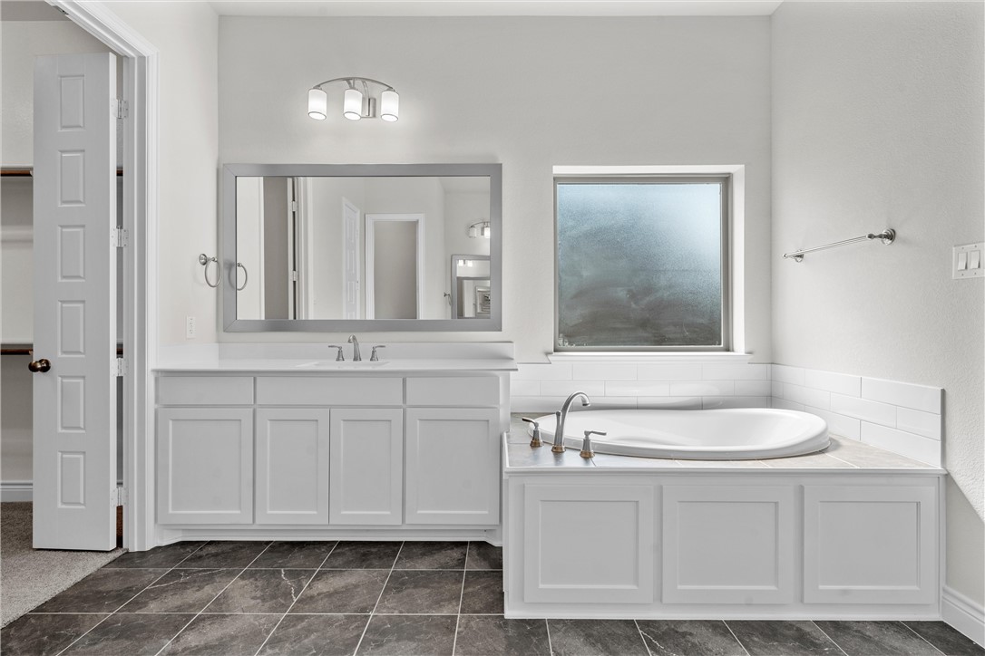 6402 Waggoner Court Temple, TX 76502 - Photo 17 of 30 a bathroom with a sink vanity and mirror