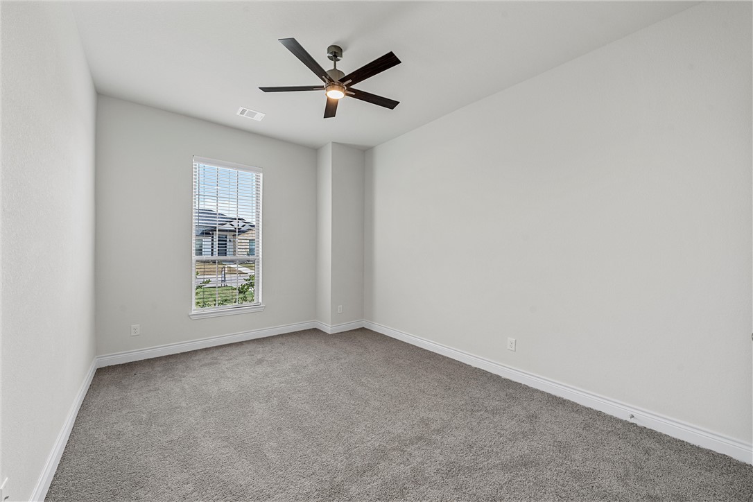 6402 Waggoner Court Temple, TX 76502 - Photo 19 of 30 an empty room with windows and ceiling fan