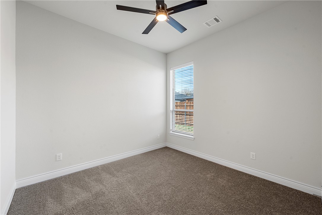 6402 Waggoner Court Temple, TX 76502 - Photo 24 of 30 an empty room with a ceiling fan and window