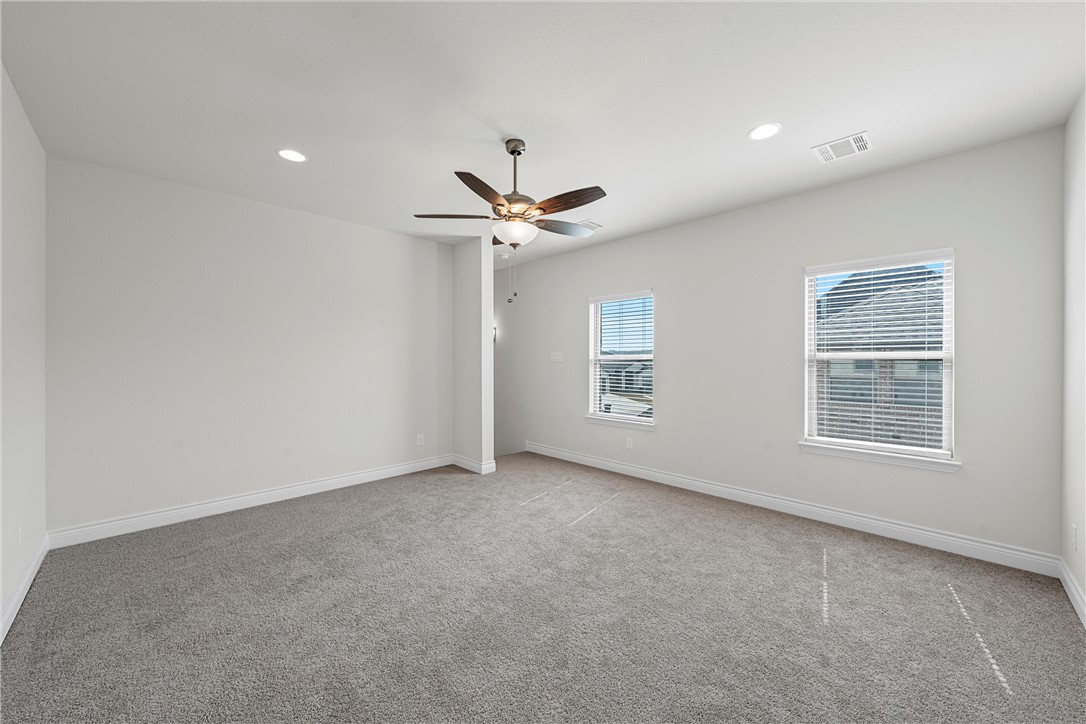 6402 Waggoner Court Temple, TX 76502 - Photo 27 of 30 an empty room with windows and ceiling fan