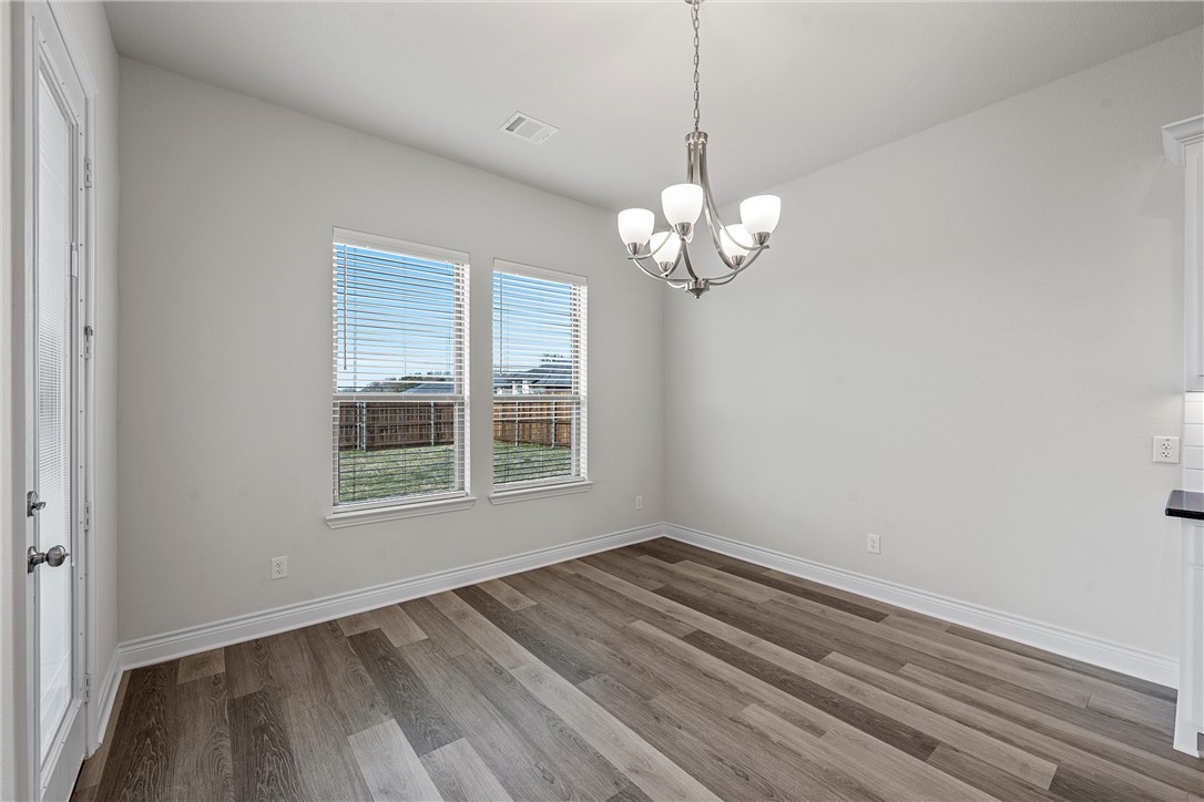 6402 Waggoner Court Temple, TX 76502 - Photo 10 of 30 a view of empty room with wooden floor and window