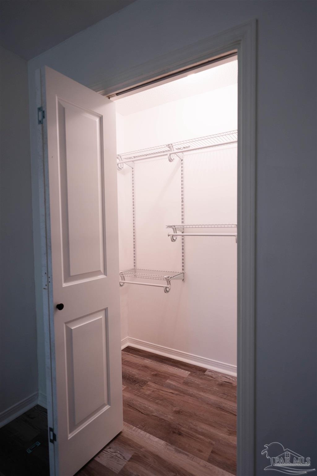 1156 Signal Hill Lane Pensacola, FL 32514 - Photo 11 of 16 a view of empty room with wooden floor and fan