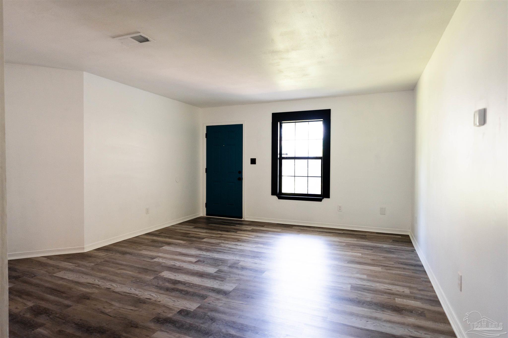 1156 Signal Hill Lane Pensacola, FL 32514 - Photo 2 of 16 an empty room with wooden floor and windows