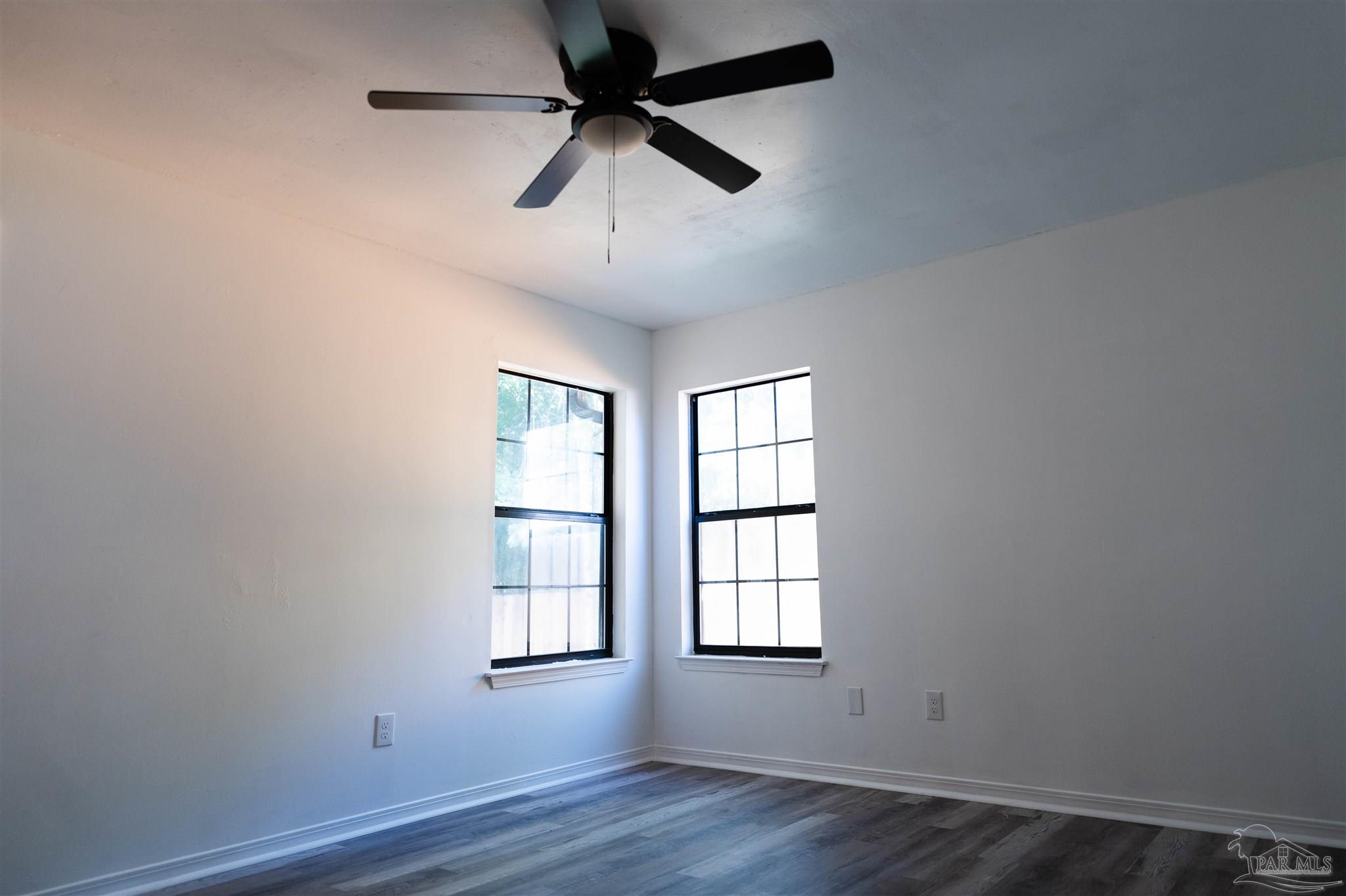 1156 Signal Hill Lane Pensacola, FL 32514 - Photo 10 of 16 an empty room with wooden floor ceiling fan and windows