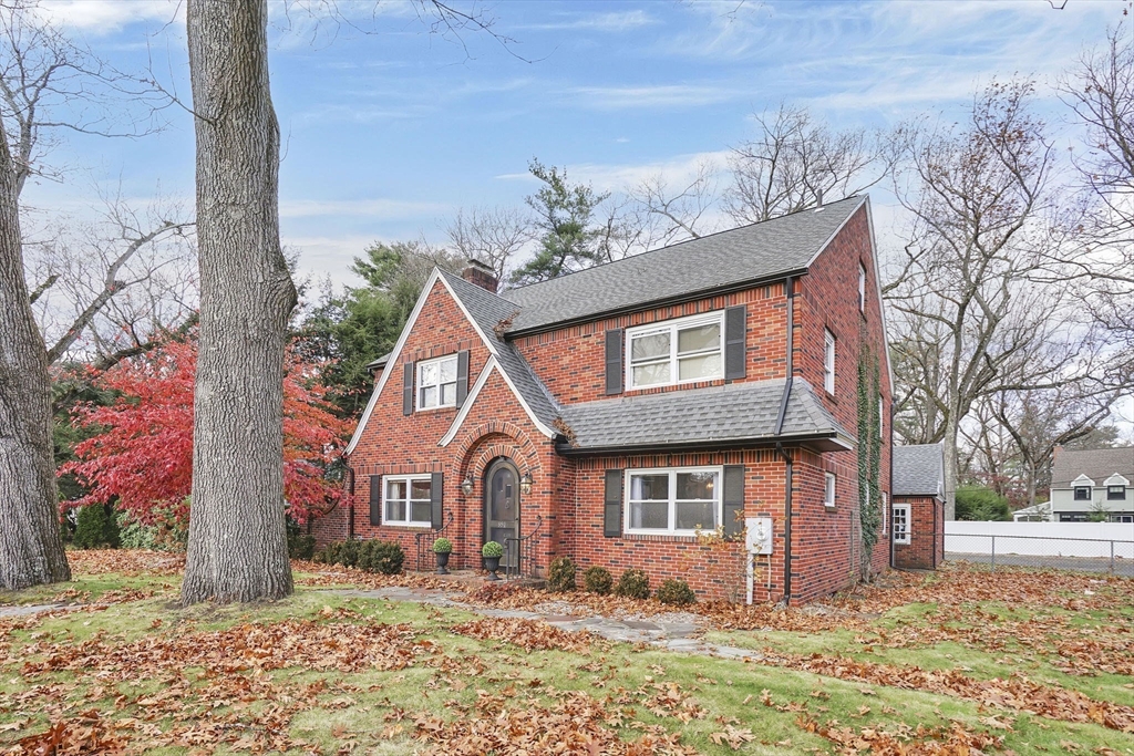 a front view of a house with a yard covered in snow