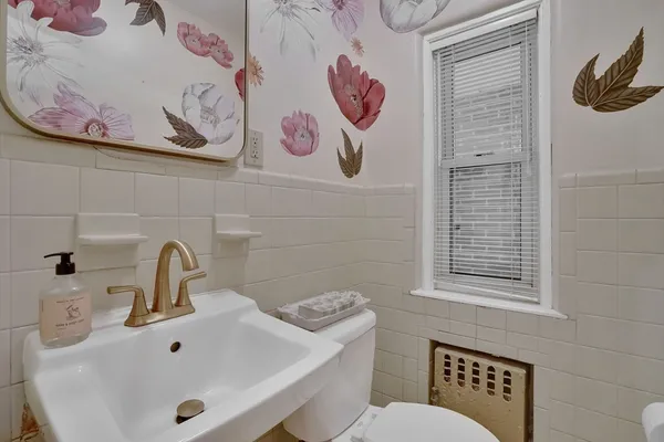 a bathroom with a sink and mirror with toilet