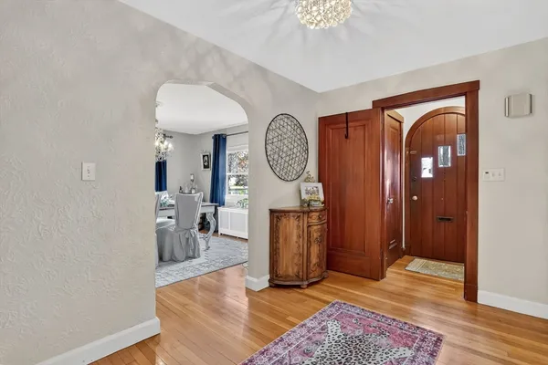 a view of a hallway with entryway wooden floor and front door