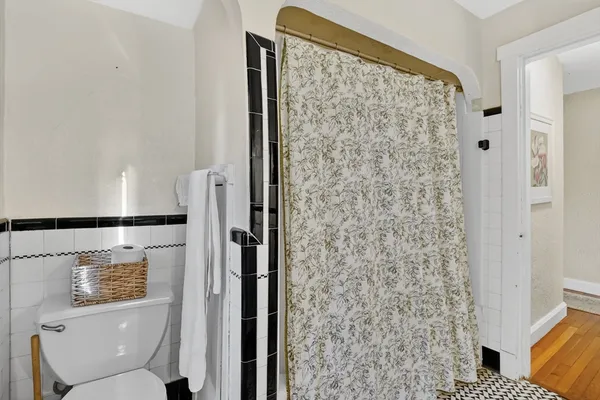 a bathroom with a toilet and a shower