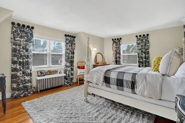 a bedroom with a bed chair and window