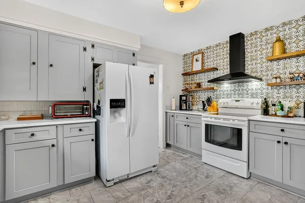 a kitchen with stainless steel appliances a stove a refrigerator and cabinets