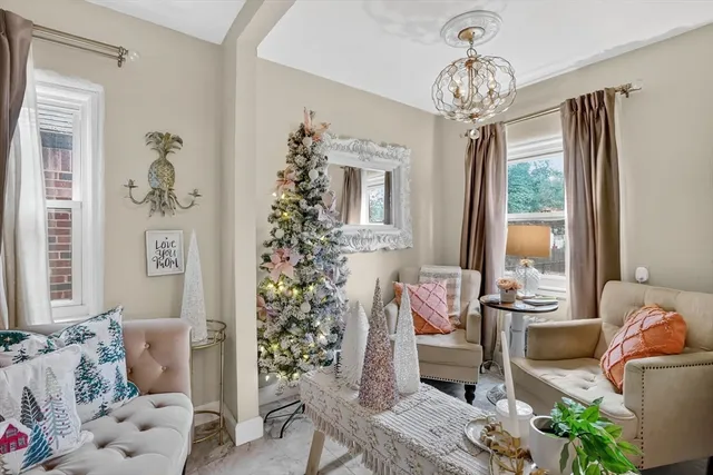 a living room with furniture and a chandelier
